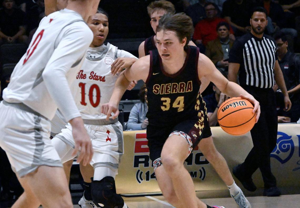 Sierra’s Logan Kilbert, right, drives up against North in the Central Section Division III Boys basketball championship Saturday, Feb. 24, 2024 at Selland Arena in Fresno..