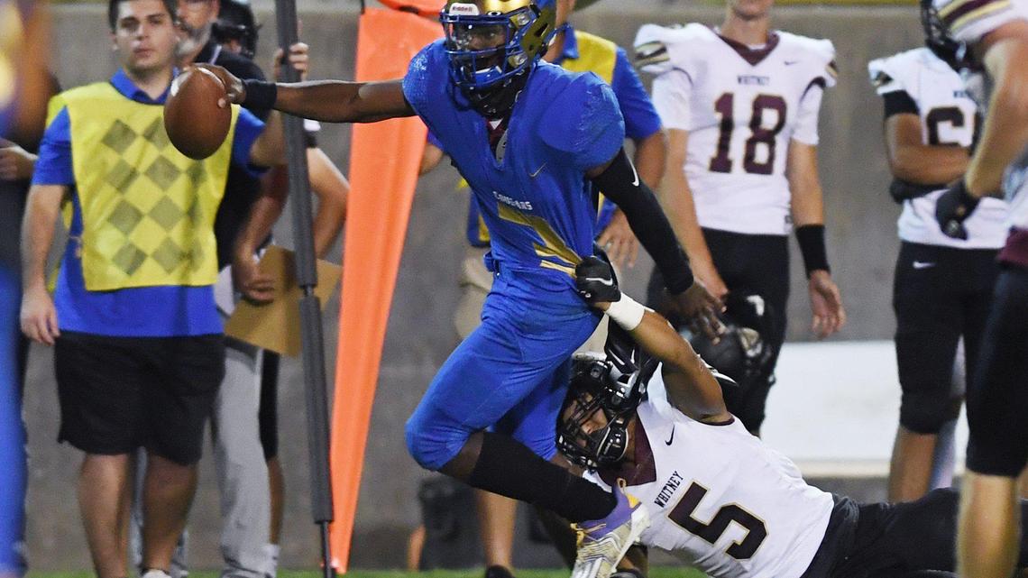 Clovis High’s Nathan Johnson, left, fights for yards against Whitney’s Brandon Wong, right, Friday, Sept. 10, 2021 in Clovis.