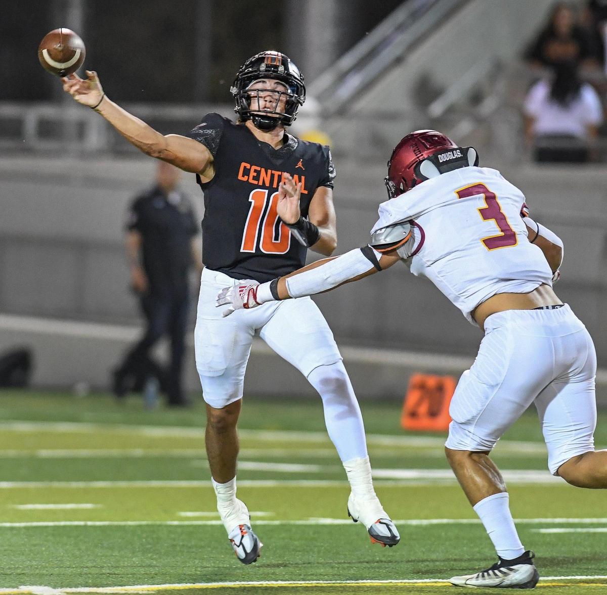 Central High quarterback Dayton Tafoya throws ahead of pressure from Clovis West’s Tytus Khajavi during their football game at Deran Koligian Stadium on Friday, Oct. 21, 2022.