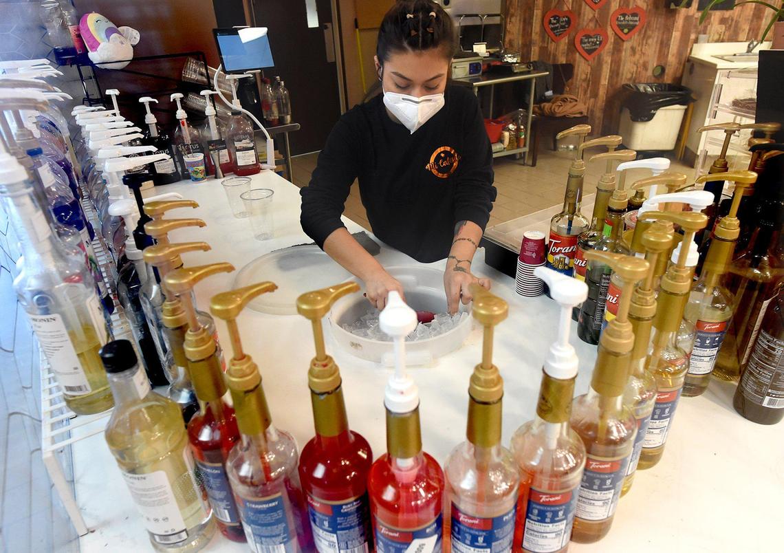 Mi Cafesito employee Johanna Rodriquez, prepares to make an energy drink, at the Latin America-themed coffee shop, tucked in a corner of Manchester Mall.