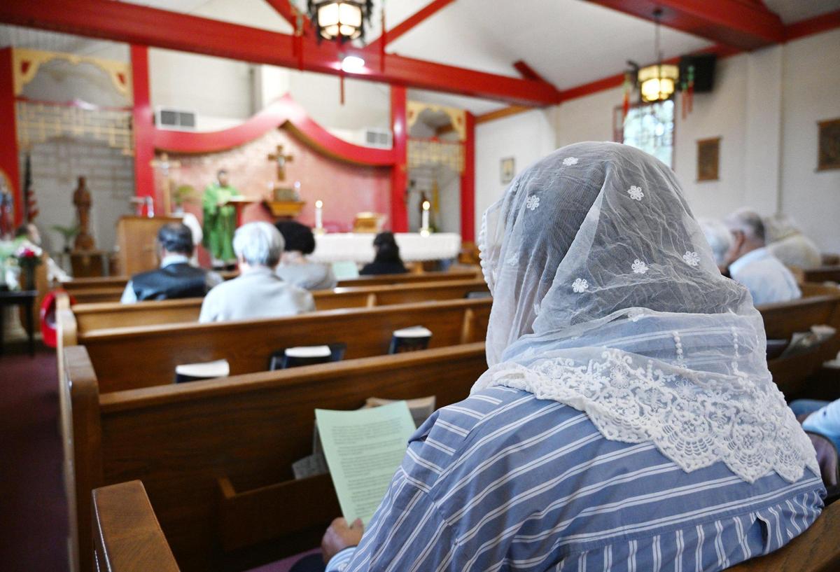 A congregant wears a shawl during Mass at St. Genevieve Catholic Church in Chinatown, Sunday, Oct. 27, 2024, in Fresno.