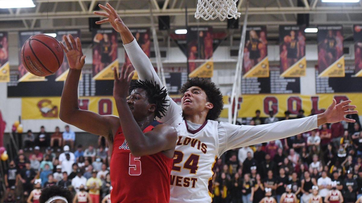 Clovis West’s Tyus Parrish-Tillman, right, blocks San Joaquin Memorial’s Mike Davis Jr’s layup in Open Division action Saturday, Feb. 19, 2022 in Fresno. Clovis West defeated San Joaquin Memorial 83-69.