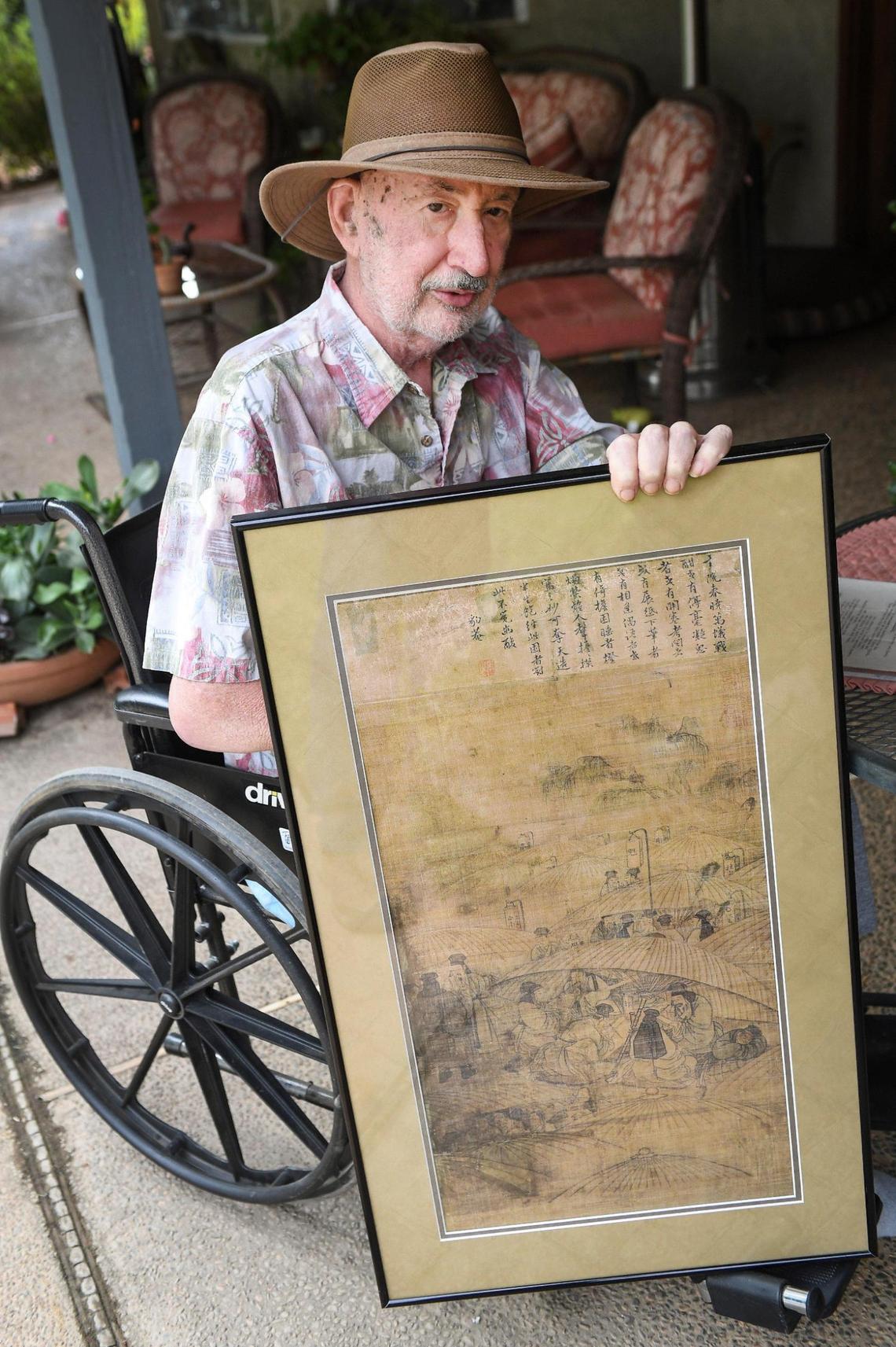 Pat Patterson of Clovis holds up a copy of a painting he purchased at an estate sale in 2002, on Tuesday, Oct. 21, 2020. The original painting turned out to be a rare piece by famous Korean artists which Patterson eventually had returned to the Korean people.