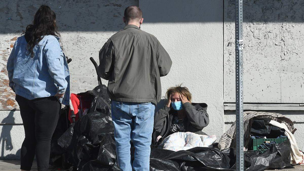 Volunteers Ashley Morris and Dylan talks with a homeless person in the Tower District during a Point in Time count last February for the Fresno-Madera Continuum of Care.