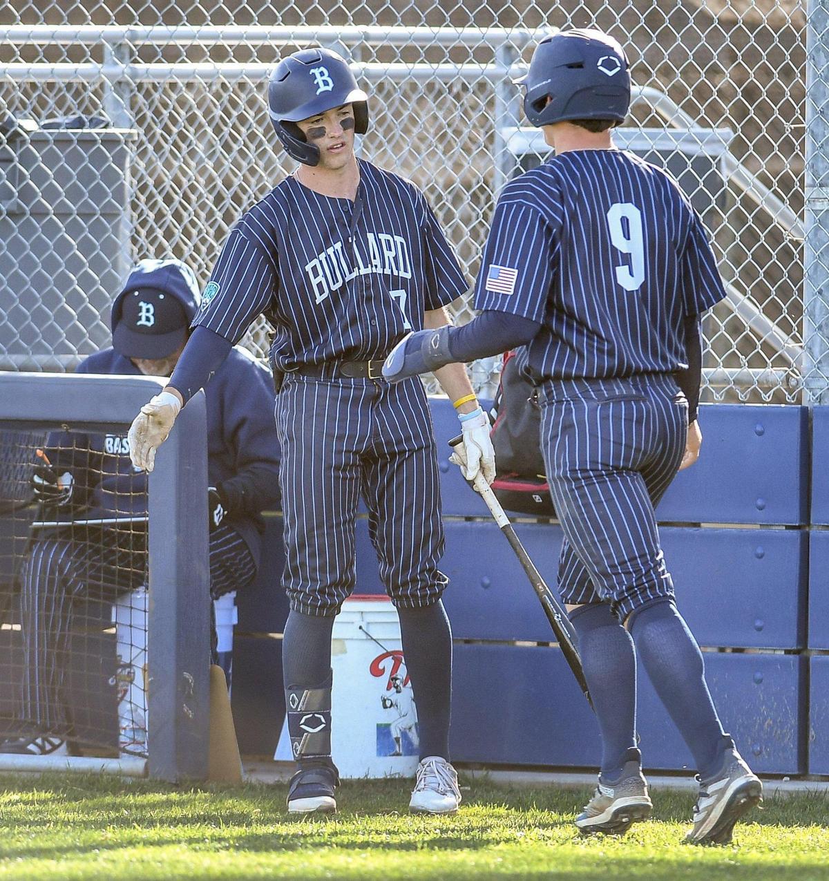 Bullard’s Nick Stubblefield, right, celebrates scoring a run with Jaxon Murphy, who stands on deck during their game against against Buhach Colony at Bullard High School on Monday, April 3, 2023.