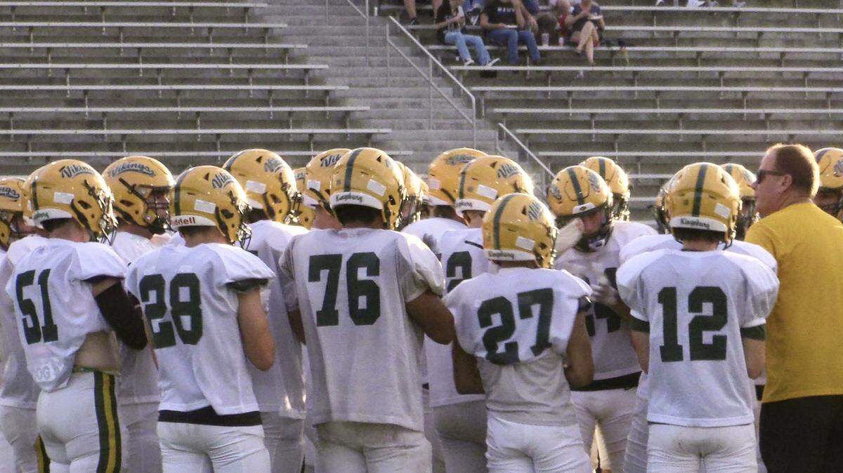 Kingsburg High football coach David Wilson talks to his team before a scrimmage against Clovis North on Thursday, Aug. 10, 2023. The Vikings will begin the new season in The Bee’s Top 25 rankings.