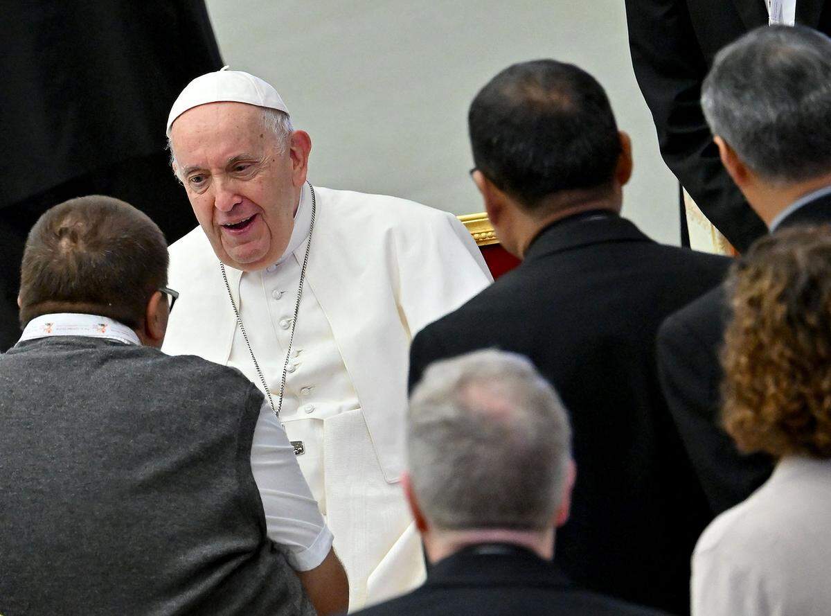 Pope Francis talks with delegates during the 16th Ordinary General Assembly of the Synod of Bishops, at Paul VI Audience Hall at the Vatican, last October. The Holy Father opened a major congress on the Catholic Church’s future vow to open doors to “everyone” despite tensions with conservatives on issues from LGBTQ faithful to the treatment of divorcees.