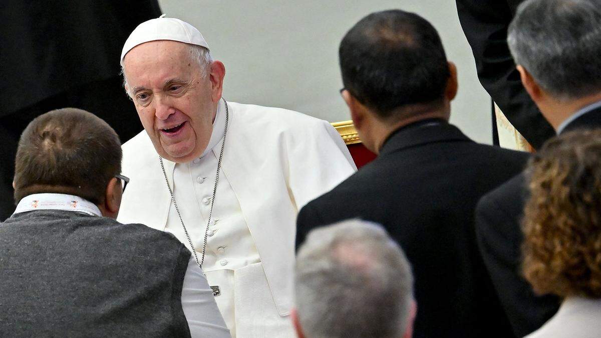 Pope Francis talks with delegates during the 16th Ordinary General Assembly of the Synod of Bishops, at Paul VI Audience Hall at the Vatican, last October. The Holy Father opened a major congress on the Catholic Church’s future vow to open doors to “everyone” despite tensions with conservatives on issues from LGBTQ faithful to the treatment of divorcees.