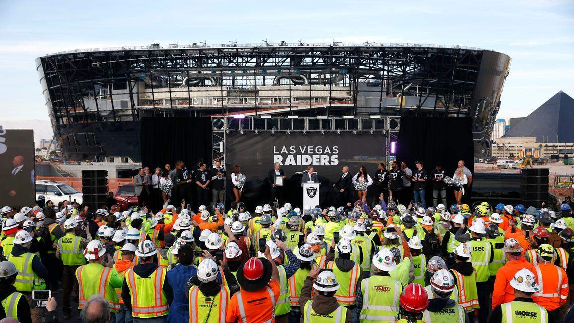 Las Vegas Raiders owner Mark Davis, center, speaks during a news conference, officially renaming the Oakland Raiders to the Las Vegas Raiders, in front of Allegiant Stadium in Las Vegas Wednesday, Jan. 22, 2020.