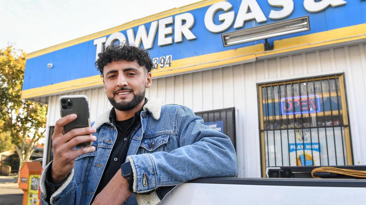 Akram Mohsin, who works at his family’s gas station, Tower Gas & Mini Mart, stands outside the gas station on Thursday, Nov. 12, 2020. Mohsin has been shooting video of nearby homeless, sharing their stories, dance moves, singing, etc. and sharing on social media. The result has been an outpouring of support for the homeless with help from followers with money and clothing.