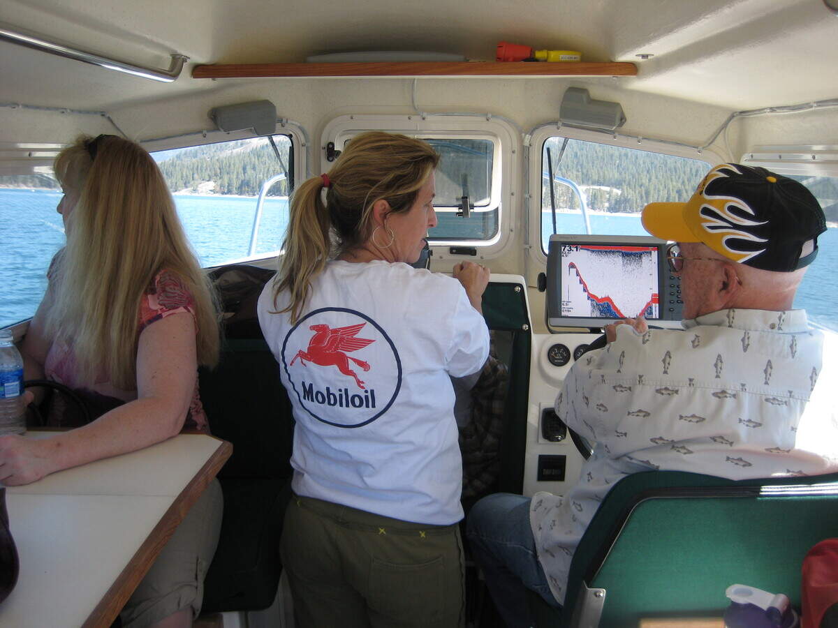Jack Yandell talks with daughter Teresa in his fishing boat on Shaver Lake.