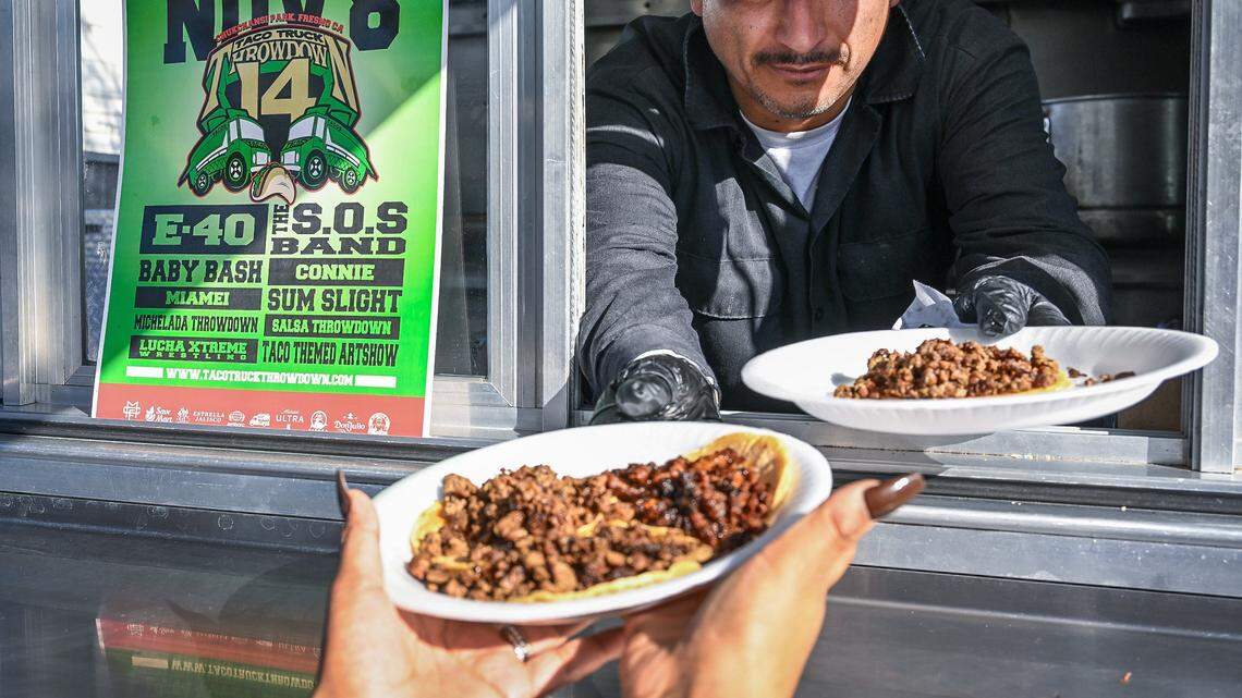 Tacos are served up at the Tacos La Vaporera taco truck next to a sign for the next Taco Truck Throwndown on Tuesday, Nov. 4, 2025.