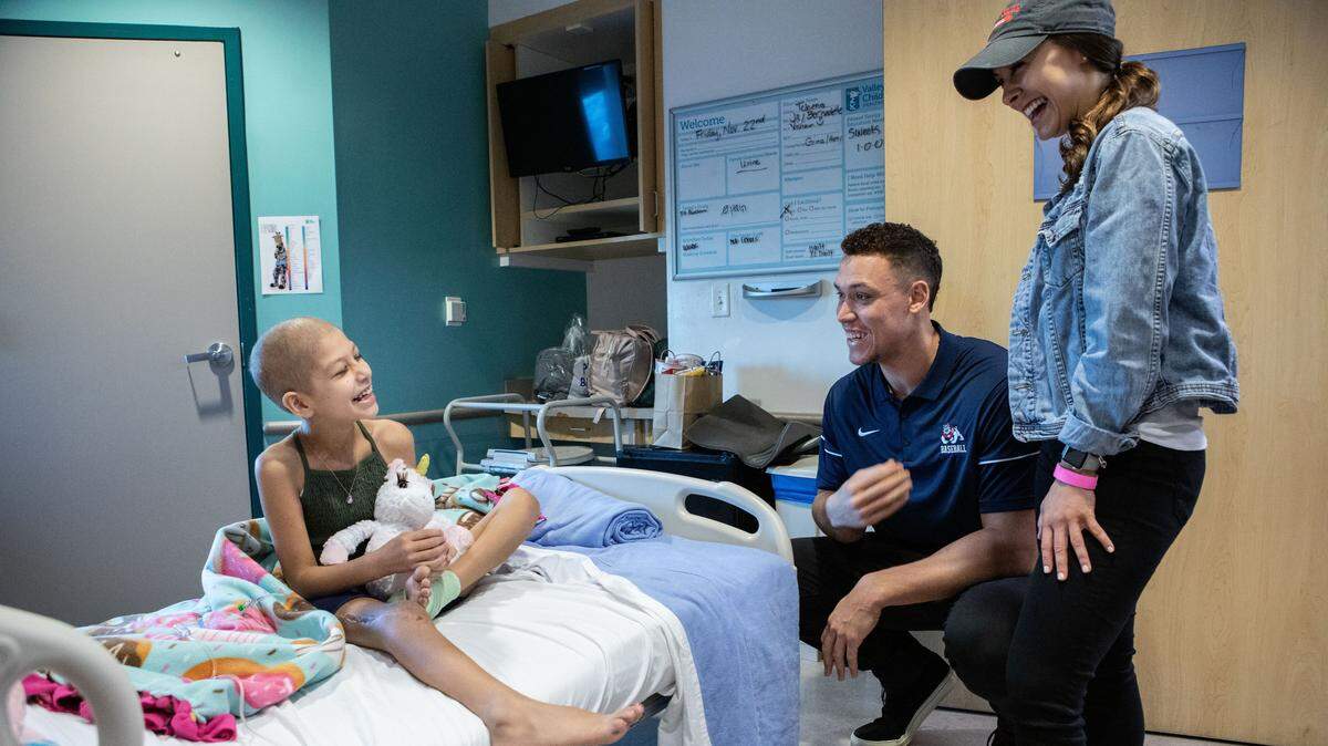 Aaron Judge and his girlfriend, Samantha Bracksieck, visit with cancer patient Natalie on Friday at Valley Children’s Hospital in Madera County, California.