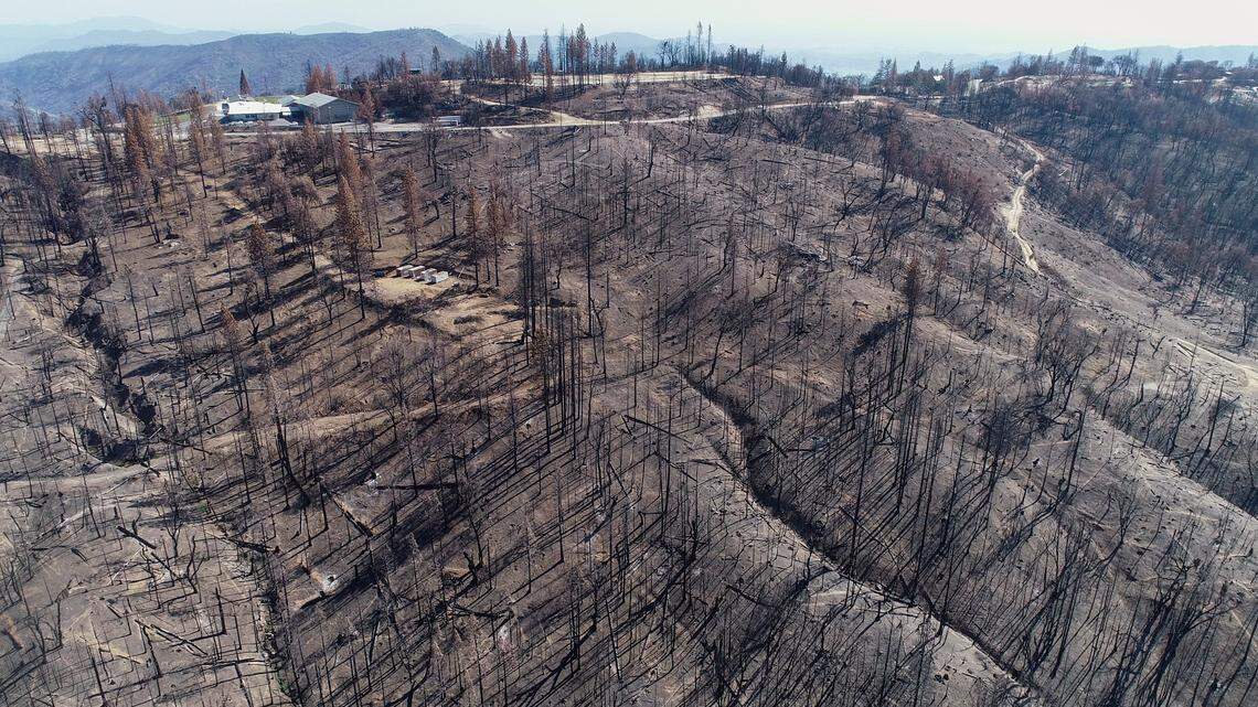 Pine Ridge School, mostly undamaged in last year’s Creek Fire, appears at upper left surrounded by mostly charred terrain in the Pine Ridge area in this drone image on Friday, April 9, 2021.