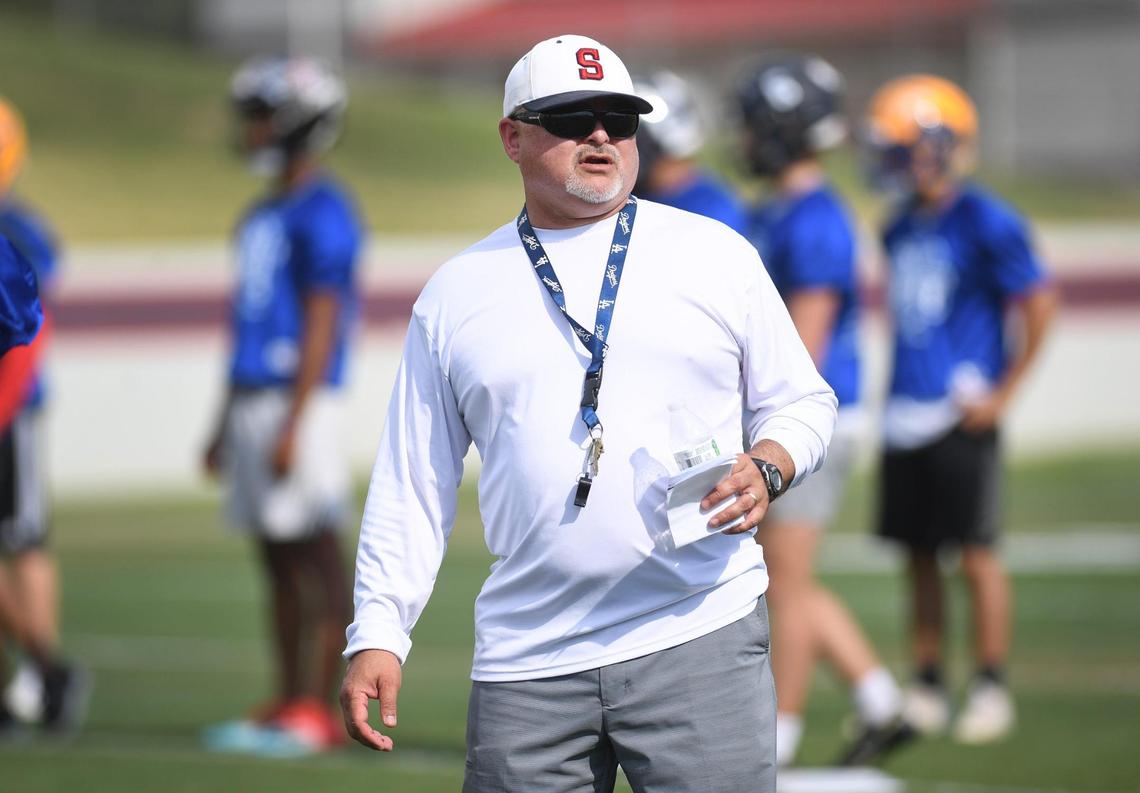 Sanger Apaches football coach Jorge Pena watches over players ahead of the annual Fresno City/County All-Star Football Game.