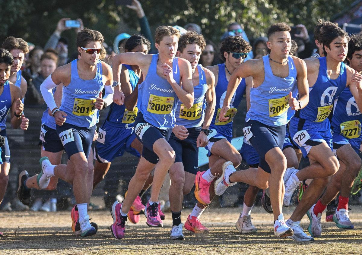 Members of the Yosemite High cross country team, from left, Jack Olney, Noah Graffigna, Anthony Ruiz and Ford Stegge start off on the course during the boys Division V state cross country championships at Woodward Park in Fresno on Saturday, Nov. 25, 2023.