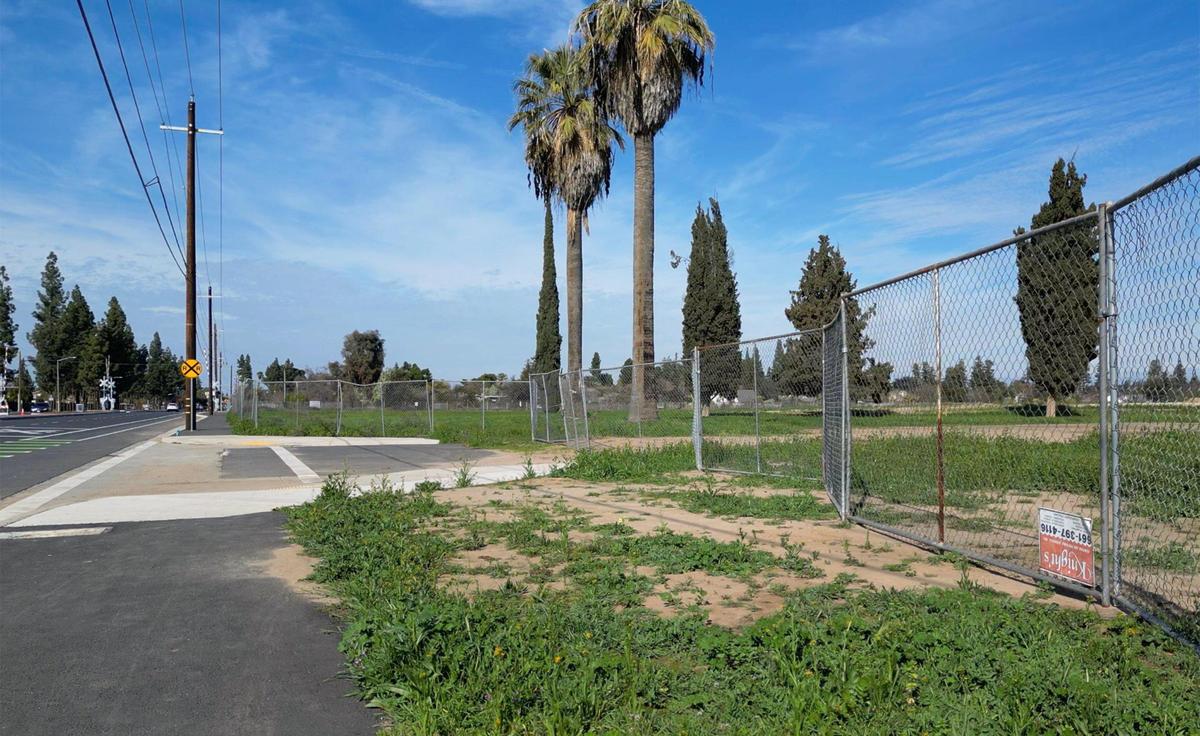The entrance to a new 49-acre park being developed along South Peach Avenue is marked with two palm trees. Photographed Wednesday, Feb. 19, 2025, in Fresno.