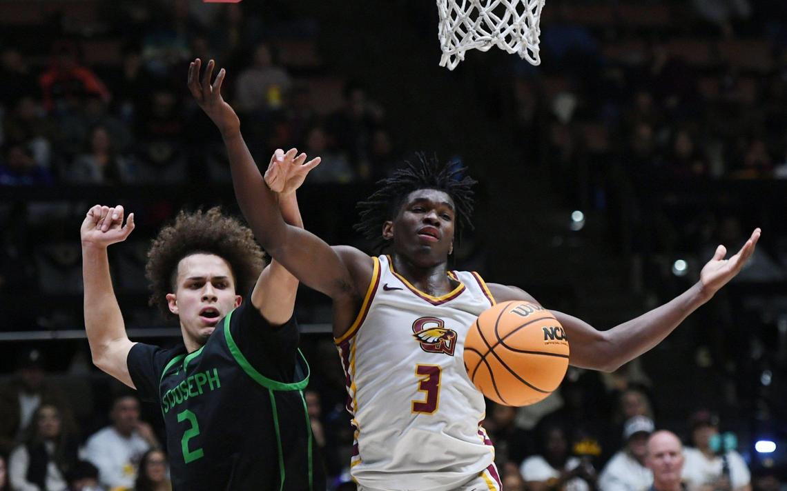 Clovis West’s Marshel Sanders, right, fouled by St. Joseph’s Luis Marin, right, in the Central Section boys Division I basketball championship Saturday, Feb. 25, 2023 in Clovis. St. Joseph won the championship beating Clovis West with a final score of 74-58.