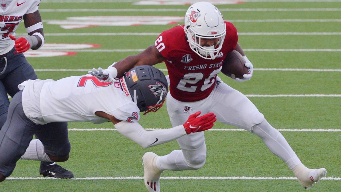 Fresno State’s running back Ronnie Rivers, right, with New Mexico’s Tony Collier to the left in the last home game for the Bulldogs Saturday, Nov. 13, 2021 in Fresno. The Bulldogs led 24-0 at halftime.