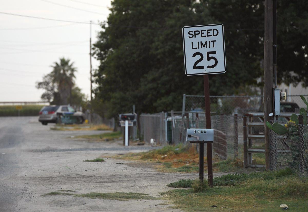 A street running through the small community of Okieville, photographed Friday, Aug. 13, 2021 in Tulare County.