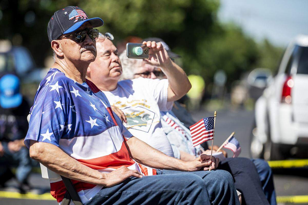 Community members look on during a flag raising ceremony inside the Castlewood community in Atwater, Calif., on Tuesday, June 14, 2022. According to Castlewood resident Sharon Wilkerson, the American flag was raised on the communitys new flag pole as a way to pay tribute to families who lived in the former Castle Air Force Base housing as well as fallen soldiers.