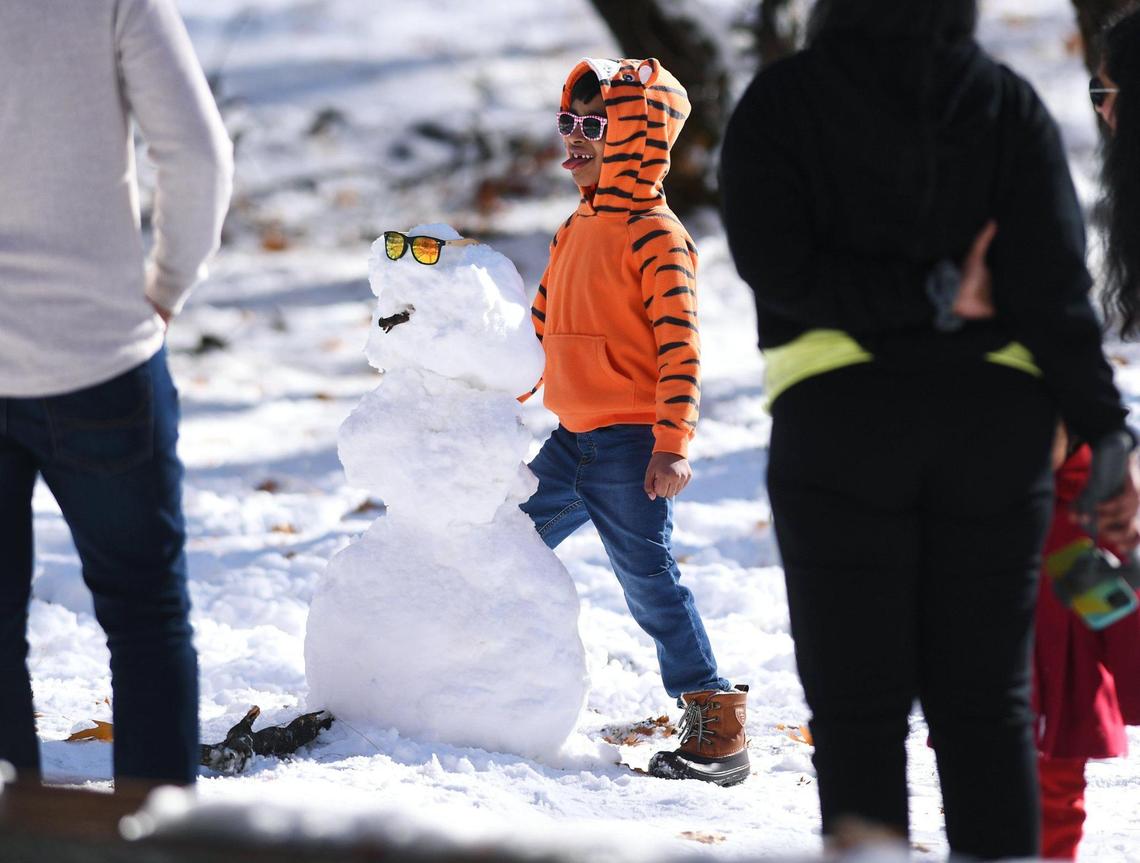 Advay Raj, 7, form San Jose, poses with a snowman he found with his family in Yosemite Valley Monday, Nov. 9, 2020, in Yosemite National Park.