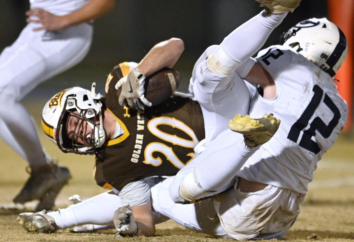 Golden West running back Case Anders, left, is tackled by Central Valley Christian’s Austin Reed, right, in the D2 semifinal championship game Friday night, Nov. 22, 2024 in Visalia.