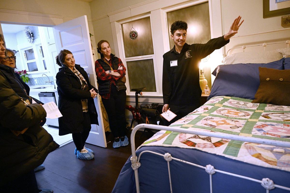 Fresno High senate member John Olmos, right, describes a bedroom’s features during the 2024 Fresno High Neighborhood Holiday Home Tour Monday evening, Dec. 2, 2024.