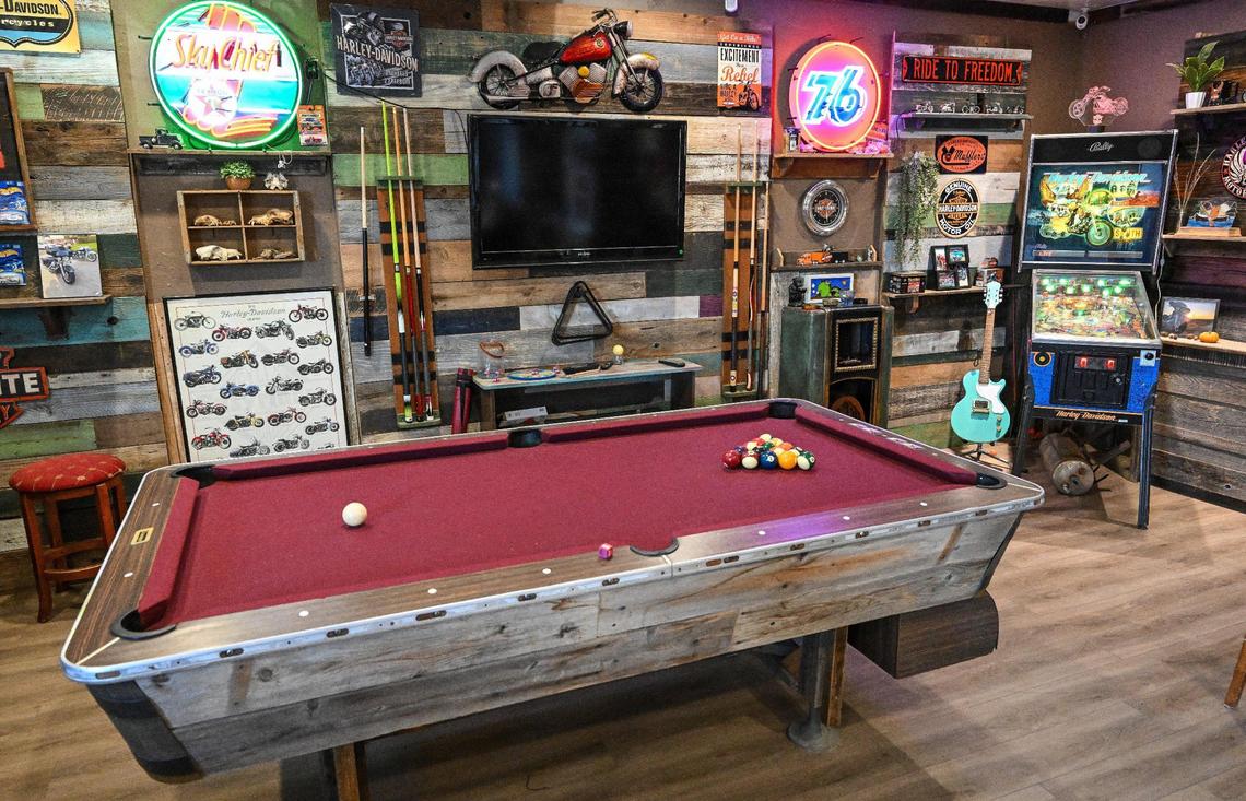 A pool table, pinball machine and lots of road signs and decorations are displayed at Yosemite Hemp Co., a CBD shop in Friant that also serves as an event space where you can find classic cars, crafted bird houses and barbecue.