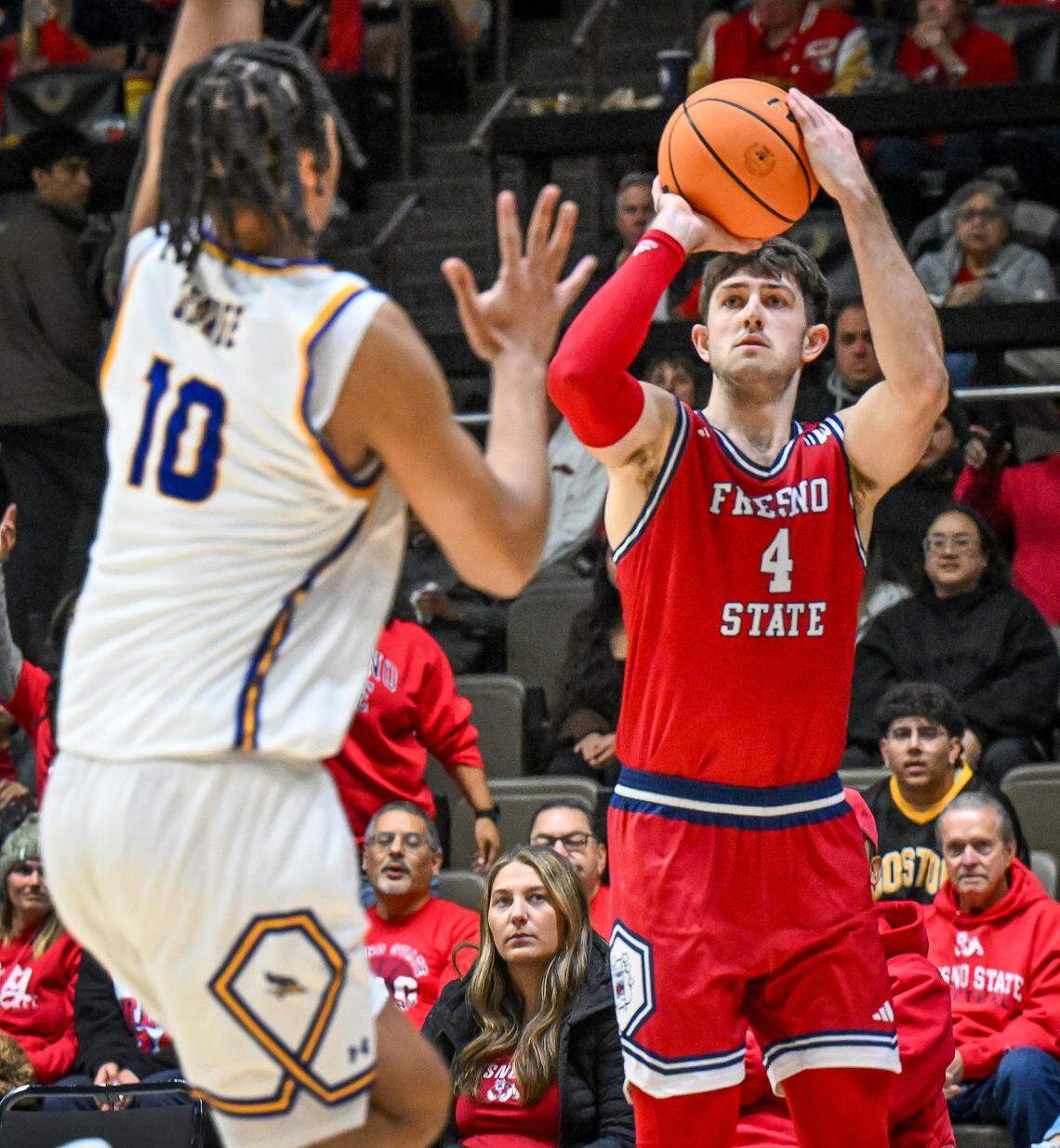 Fresno State's Cameron Faas, right, eyes a three-pointer against CSU Bakersfield's AJ George during their non-conference game at Selland Arena in downtown Fresno for the “Return to Selland” game on Sunday, Nov. 30, 2025.