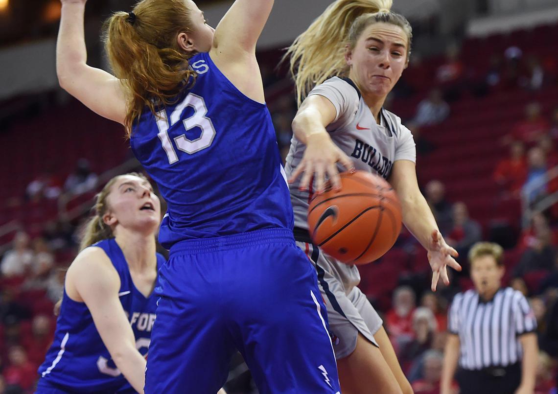 Fresno State guard Hanna Cavinder, right, slips a pass behind Air Force’s Emily Conroe, center, Wednesday, Jan. 29, 2020 in Fresno.