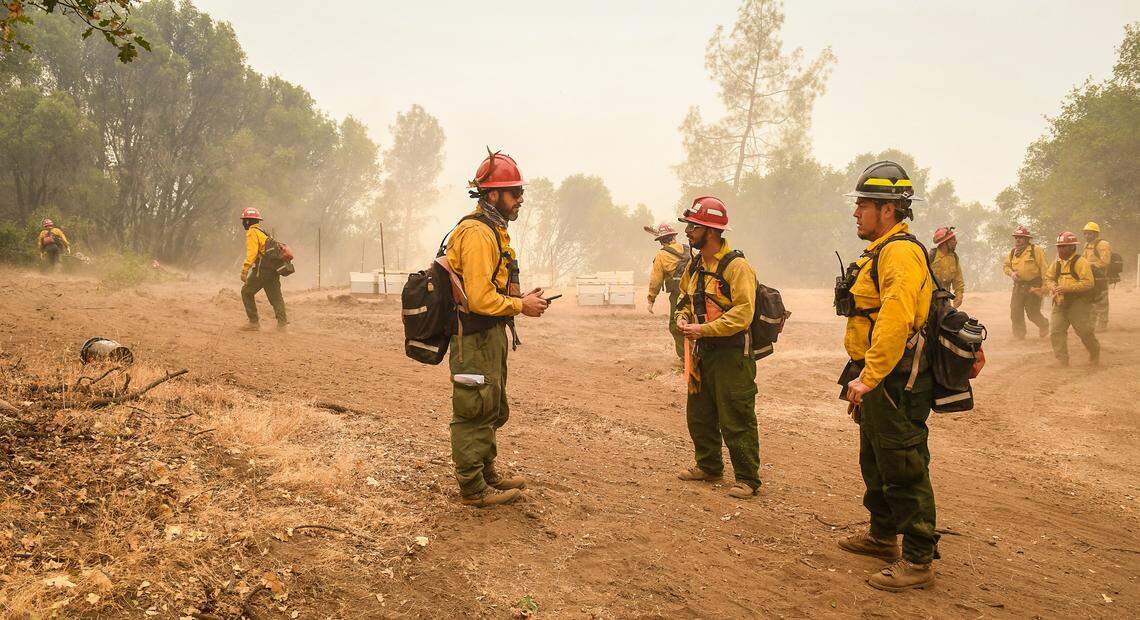 A fire crew coordinates an effort to construct a fire break line in the Cascadel Woods area east of North Fork on Thursday, Sept. 10, 2020. The weather has helped with the firefighting efforts on the Creek Fire with far less wind and an inversion layer calming down fire activity.