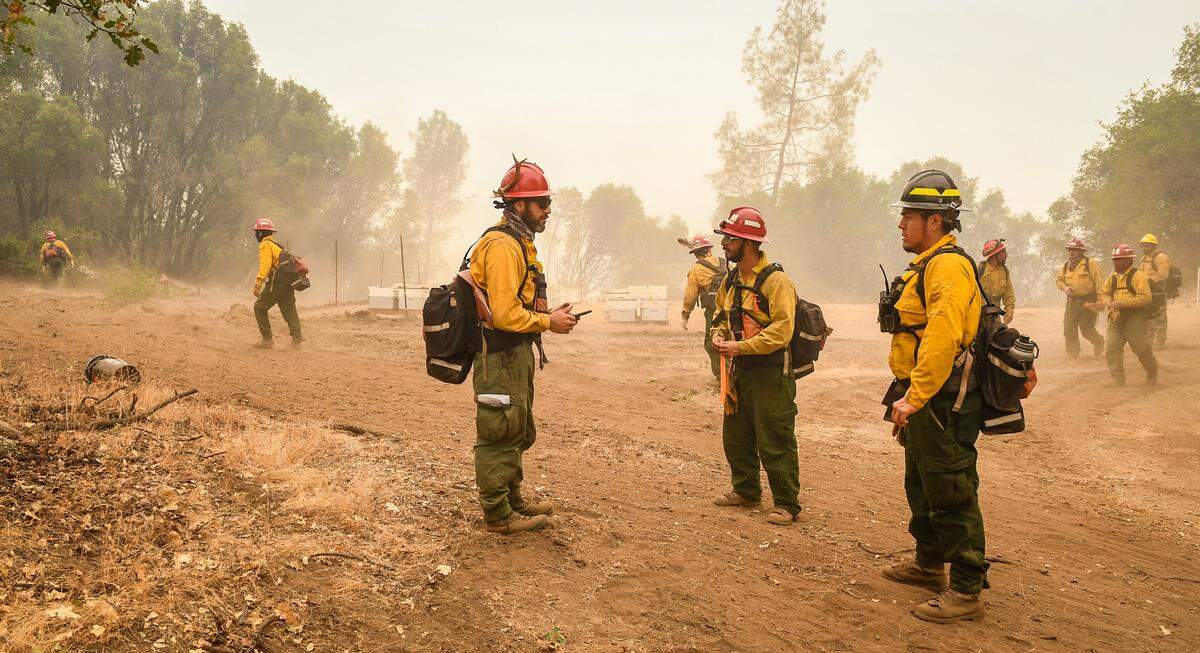 A fire crew coordinates an effort to construct a fire break line in the Cascadel Woods area east of North Fork on Thursday, Sept. 10, 2020. The weather has helped with the firefighting efforts on the Creek Fire with far less wind and an inversion layer calming down fire activity.
