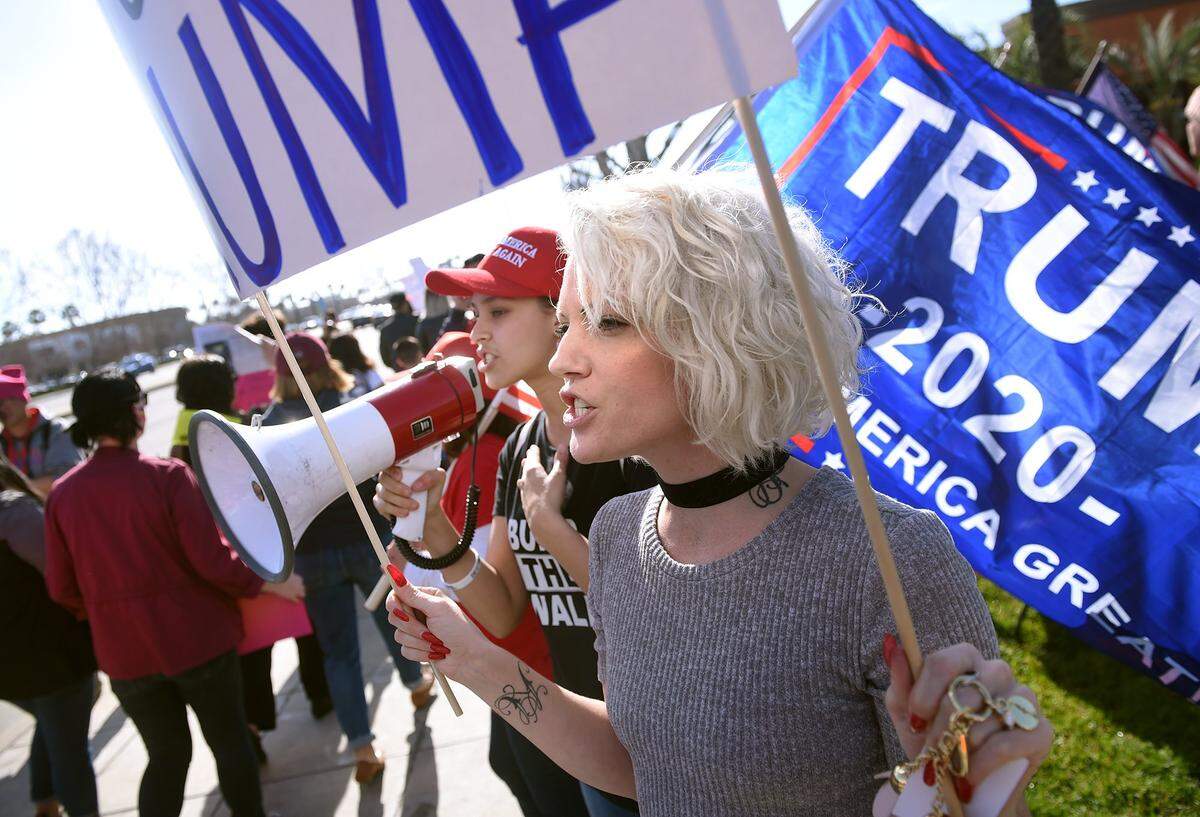 Trump-supporters Maddie Mueller, background center, and Ashlee Stephens, center foreground, shout at Women’s March supporters at the third annual Women’s March, held Saturday, Jan. 19, 2019 in Fresno.