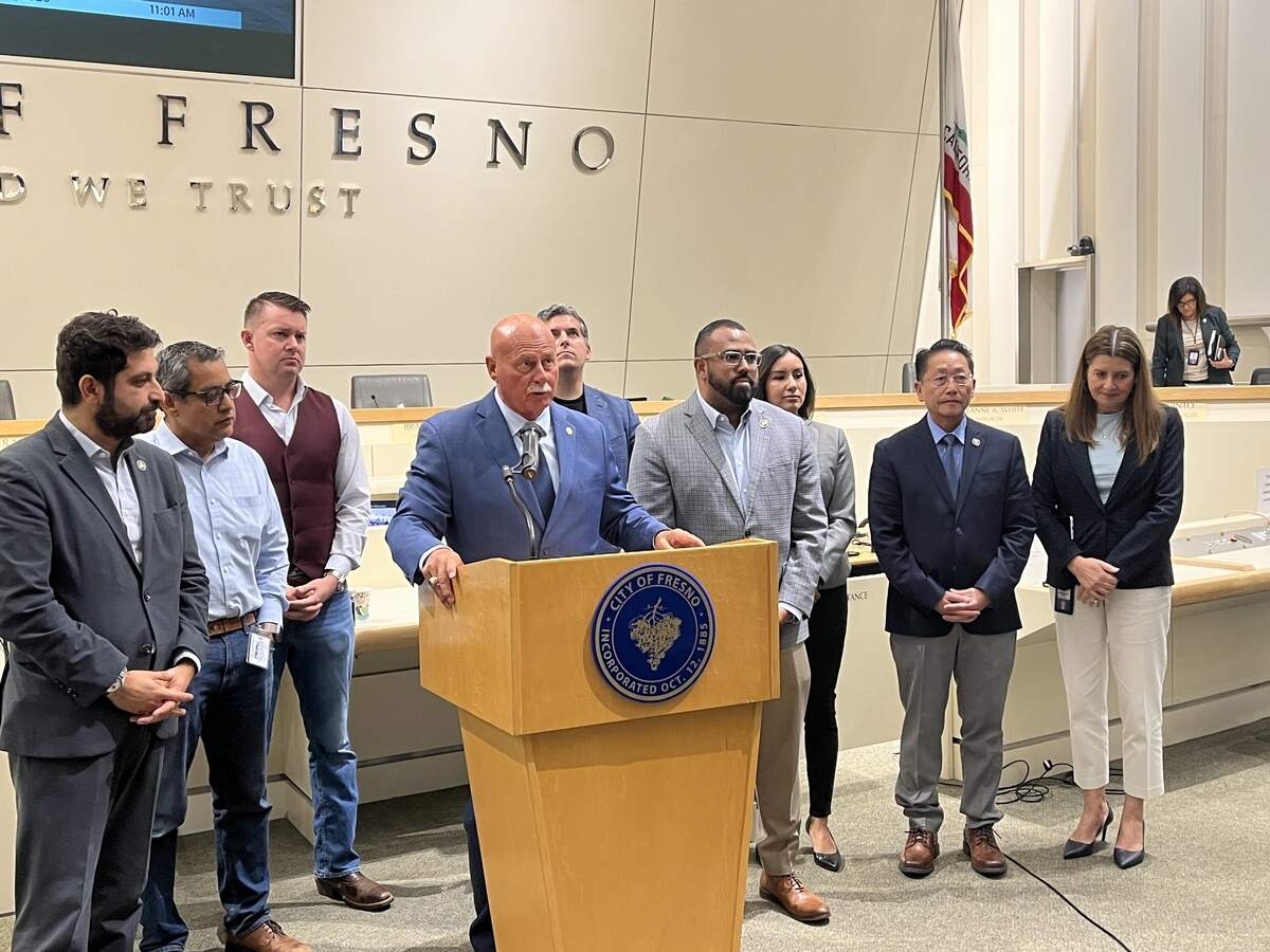 Fresno Mayor Jerry Dyer, at lectern, and the Fresno City Council, along with City manager Georgeanne White, far right, talk to the media after the city council passed the $2.6 billion budget.
