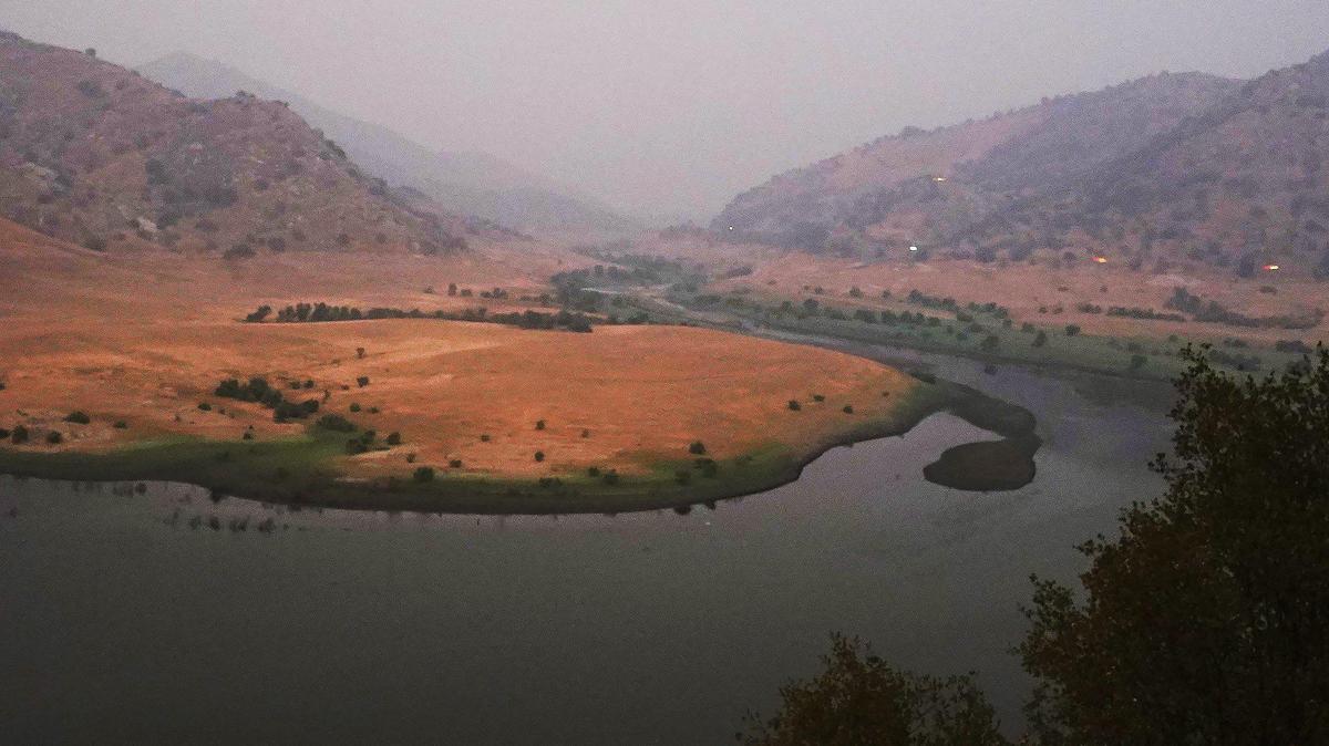 Lake Kaweah is shrouded in smoke from the KNP Complex fire burn, seen at dusk Thursday, Sept. 30, 2021 near Three Rivers, CA.