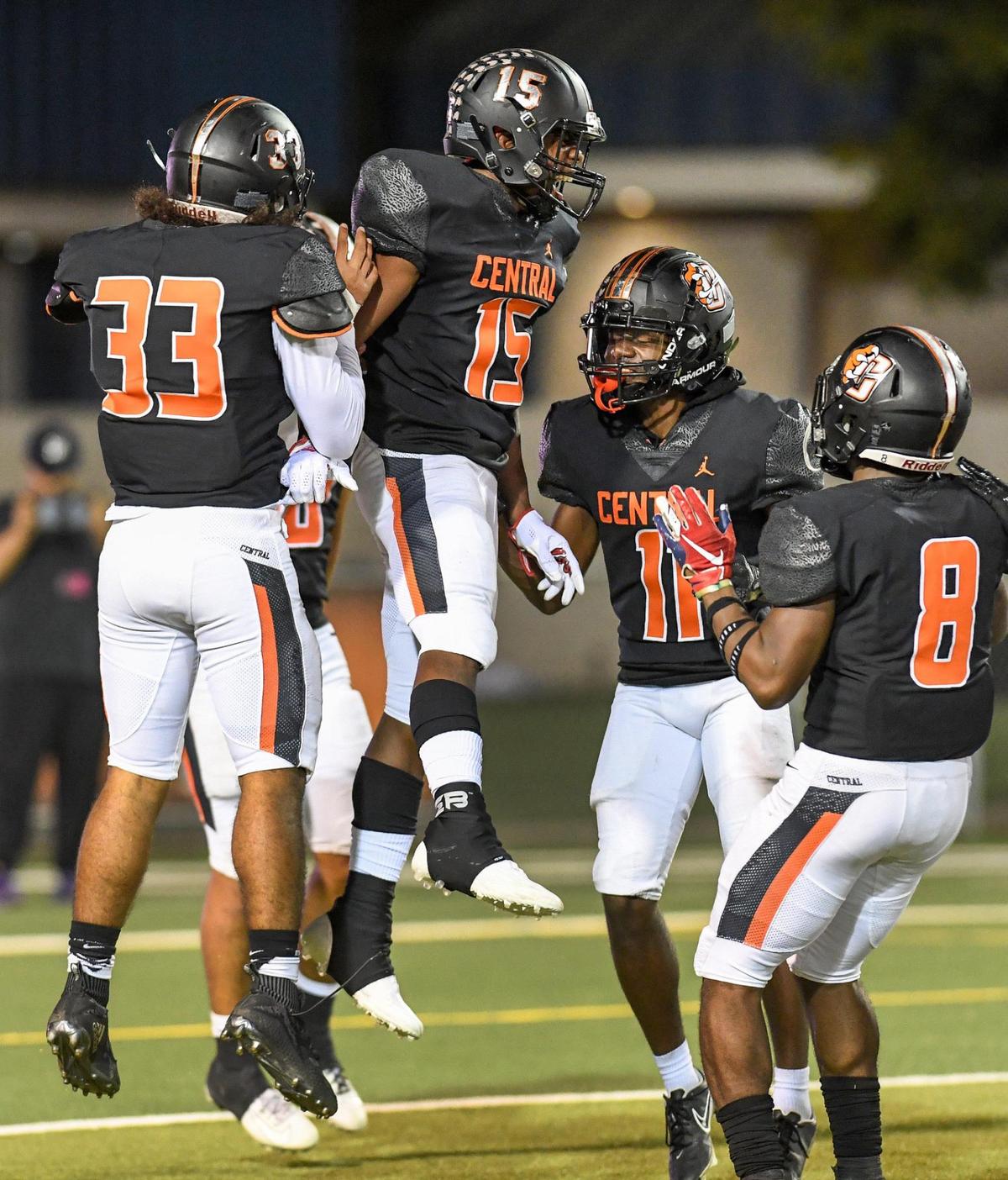 Central’s Imari Conley, center, celebrates with teammates after picking off a pass from Clovis West during their football game at Deran Koligian Stadium on Friday, Oct. 21, 2022.