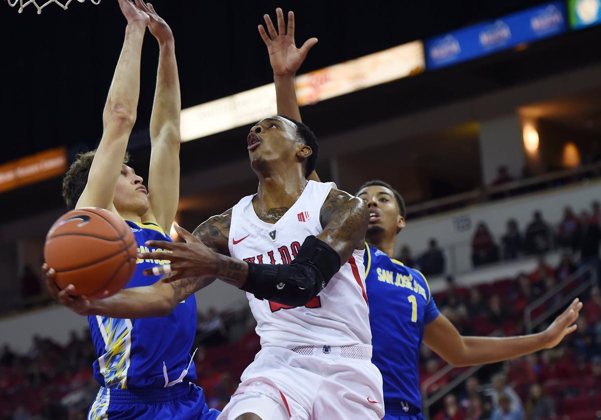 Fresno State guard Deshon Taylor drives by San Jose State’s Brae Ivey, left, and Michael Steadman, right, in the first half of the Bulldogs’ 121-81 victory over the Spartans Saturday, March 9, 2019 in Fresno.