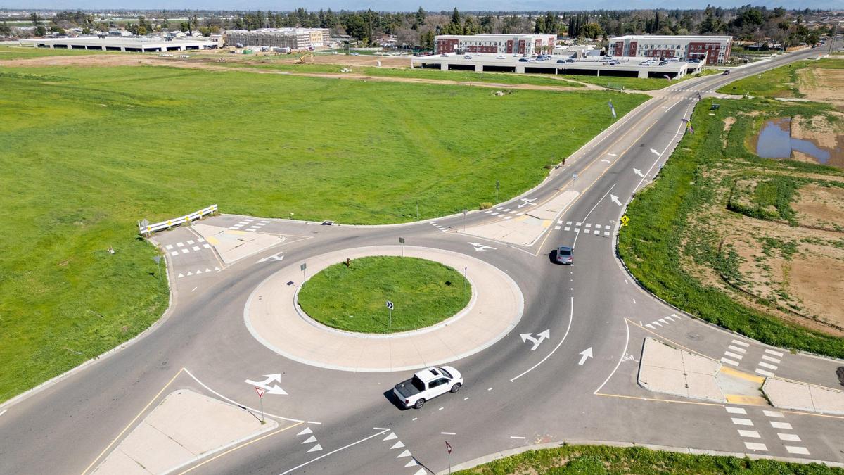An aerial view shows the land that will be developed as part of Fancher Creek at Clovis Avenue and Tulare Street in southeast Fresno. Apartments for seniors and low-income families, pictured in the background, have already been built.
