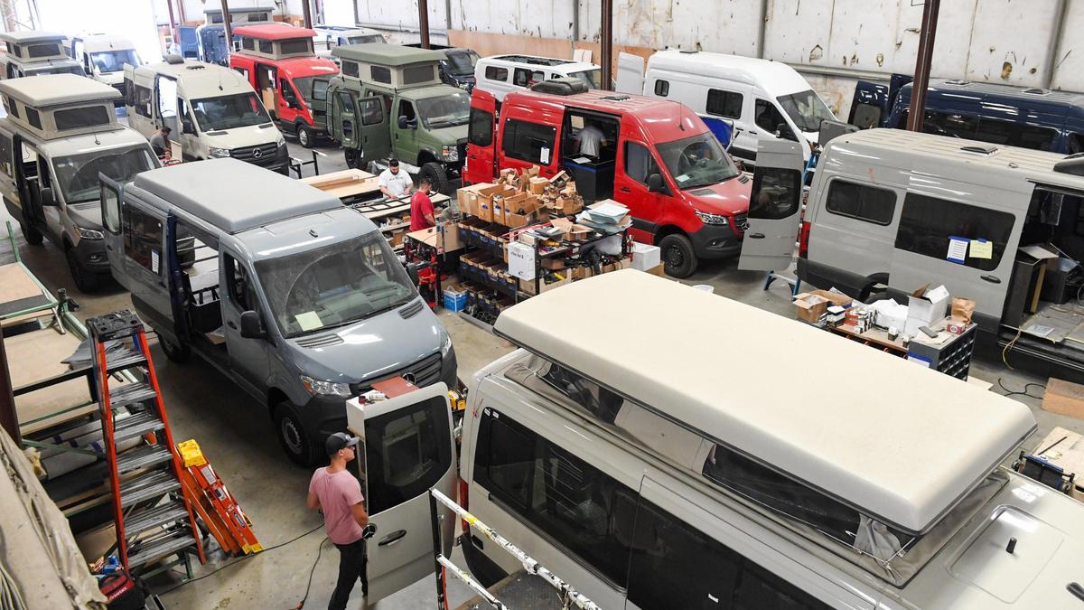 A number of camper van conversions are shown in various states of completion on the floor at Field Van in Fresno on Wednesday, Aug 11, 2021.