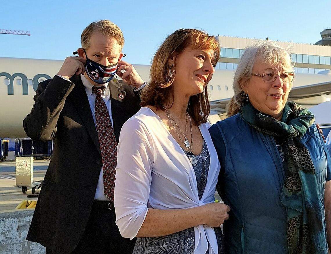 Cindy Garcia, center, and Patricia Hanse Verheul, right, along with Jim Lovelace, watch as the remains of their family member, Marine Pfc. Royal Waltz, killed during World War II, arrive at the Los Angeles International Airport on Sept. 23, 2021.