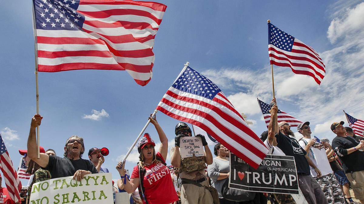 Anti-Sharia protesters at the site of the San Bernardino terrorist attack as part of a nationwide “March Against Sharia” event sponsored by the conservative group Act for America on Saturday, June 10, 2017. Protesters chanted “USA!” and waved signs, including one that said “Islam is not American,” near the county’s Inland Regional Center, where a Pakistani American couple fatally shot 14 people in 2015.