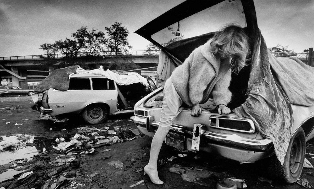 In a muddy field near a Highway 41 overpass in downtown Fresno, Jackie Staples, a homeless woman living out of a broken-down car, steps out for the evening in 1986. Her prized possession: A teddy bear that played “It’s a Small World.”