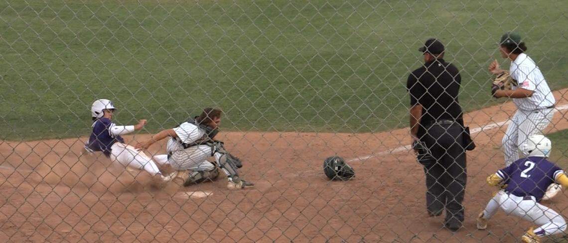 Davin Finderup of Washington Union slides home against Kingsburg in a Central Section Division II semifinal game. He was called out.