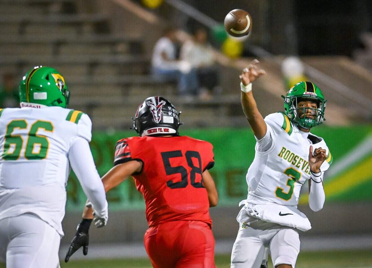 Roosevelt quarterback CJ Barker throws downfield while getting pressure from McLane's Greg Ramirez during their North Yosemite League showdown at McLane Stadium on Thursday, Oct. 9, 2025.
