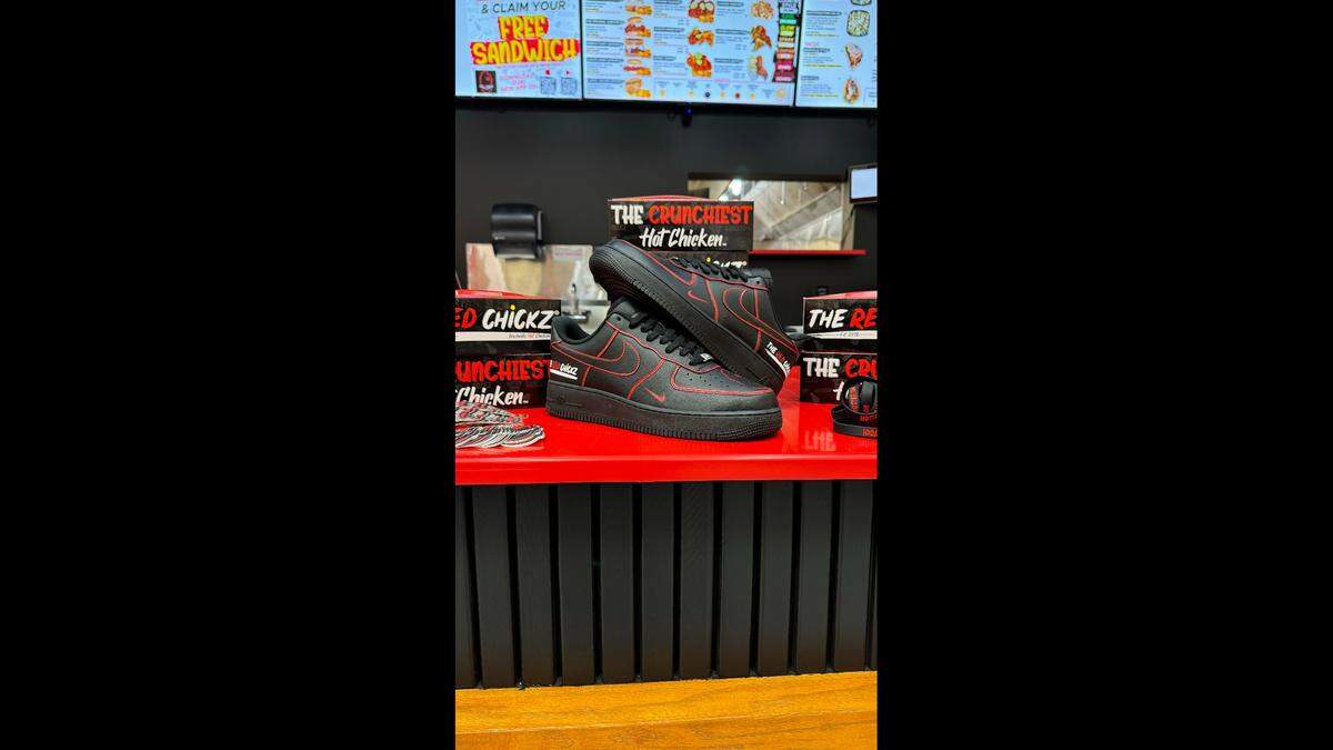 The Red Chickz will raffle this custom pair of Nike sneakers at its grand opening Saturday, Aug. 10.