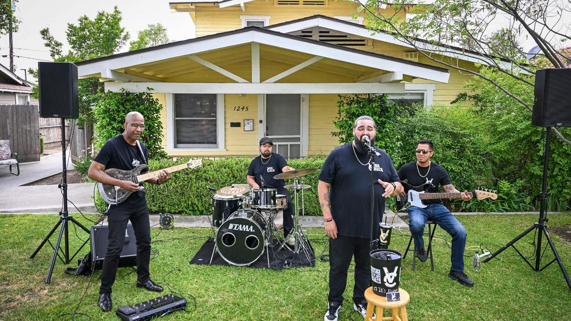 Ralph Edwards sings while, from left, Bobby Griffin, Gene Abella and Marco Flores with the band Vibe Check perform during a rehearsal in front of a home in Fresno’s Tower District in preparation for this year’s Tower Porchfest, on Thursday, April 17, 2025.