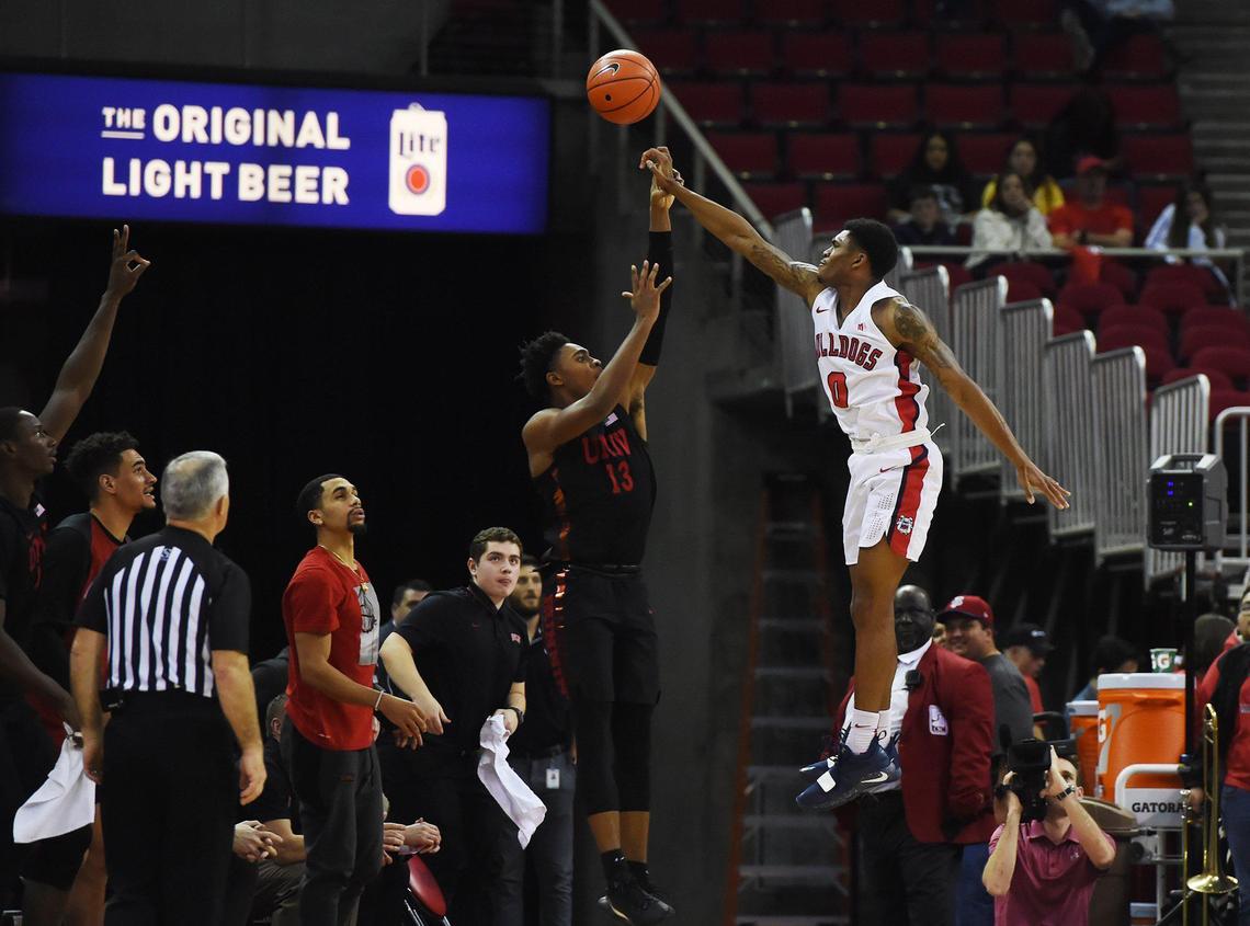 Fresno State guard New Williams, right, blocks UNLV’s Bryce Hamilton’s shot in the Bulldogs’ Mountain West opener Wednesday, Dec. 4, 2019 in Fresno. UNLV won 81-80 in double overtime.