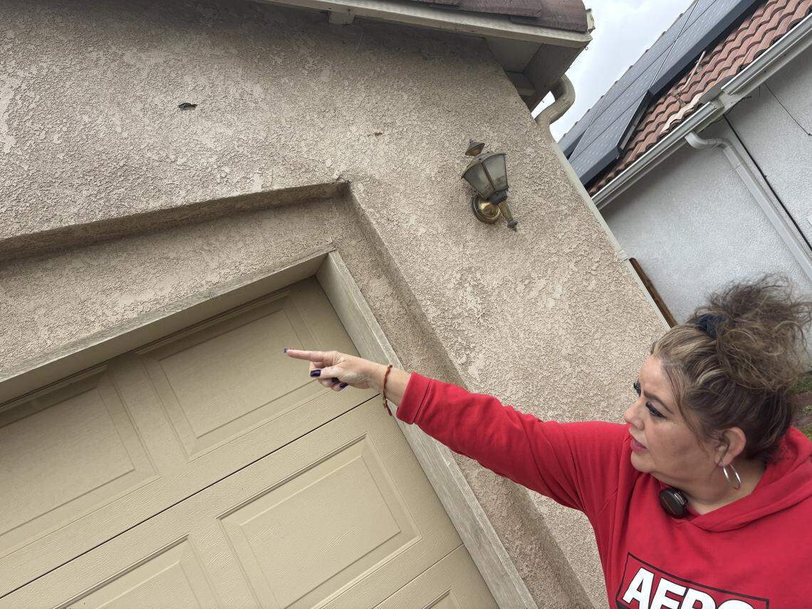 Daniela Pedraza on Monday, April 13, 2026 points to bullet holes in a house in Porterville, California that were fired during a standoff with law enforcement on April 9. A deputy with the Tulare County Sheriff’s Office, Randy Hoppert, was shot and killed during the incident.