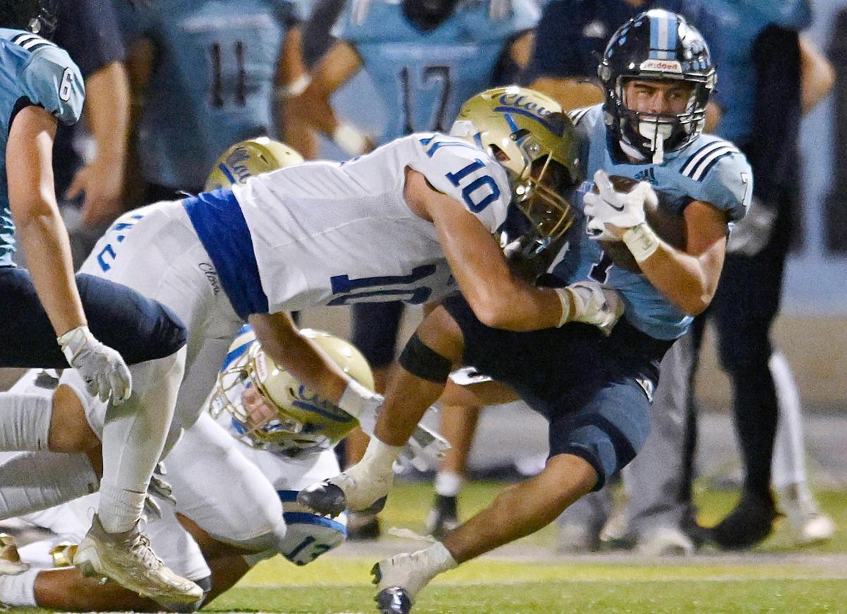 Clovis High’s John Villanueva, left, tackles Bullard’s Dominick Gonzalez, right, Friday, Sept. 15, 2023 in Fresno.